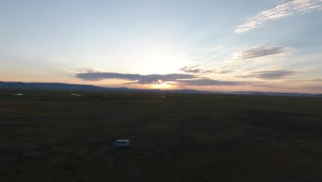 Beautiful-aerial-drone-shot-of-a-moving-russian-van-in-mongolian-steppes